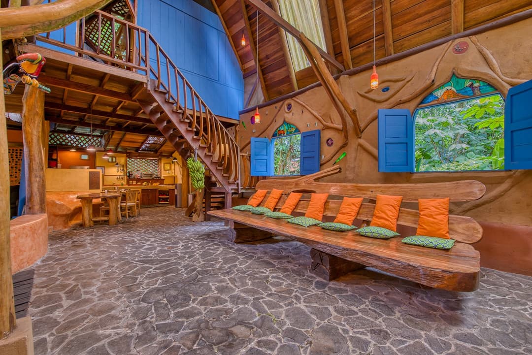 Living room of the Crystal House with recycled-art surfaces on every wall